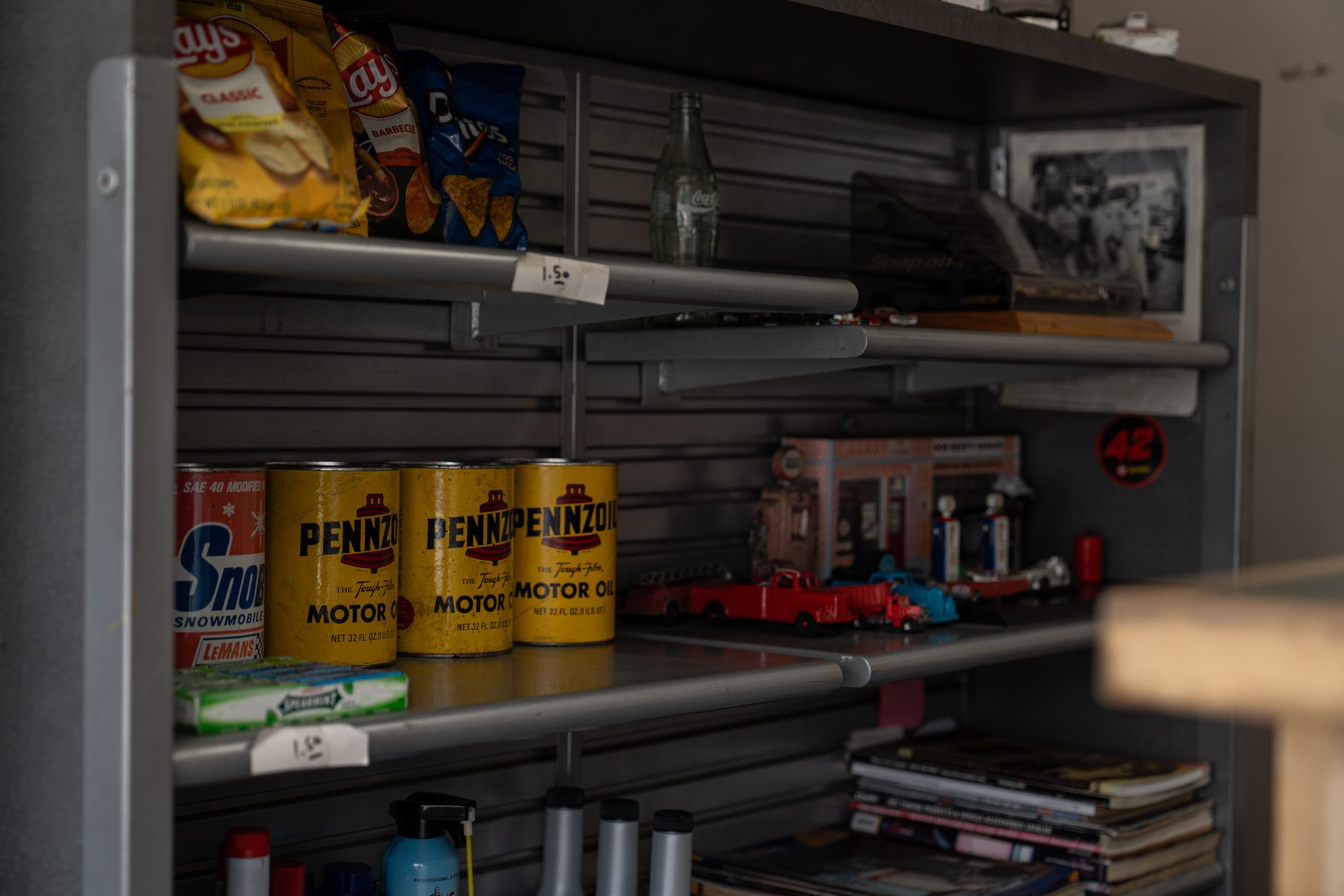 Vintage shelving with motor oil cans and collectibles