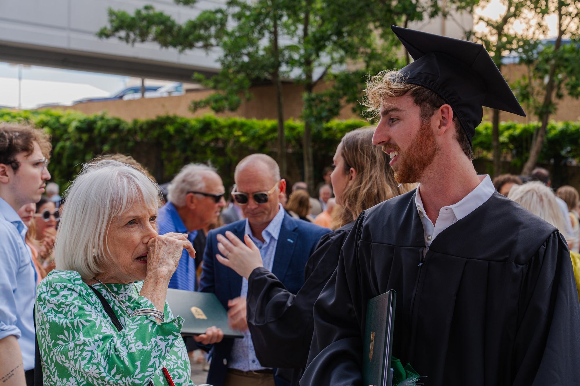 Graduate talking with grandmother