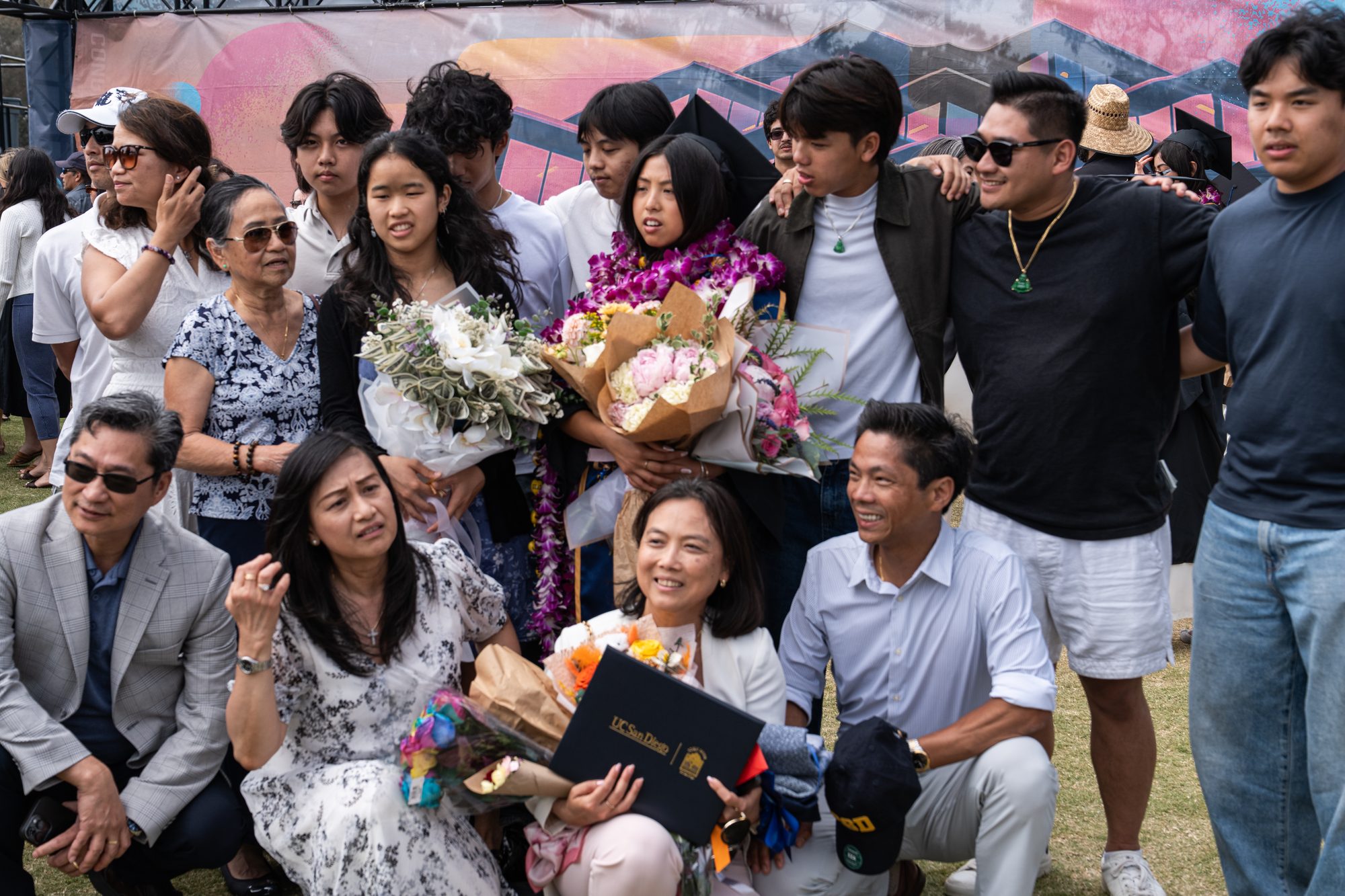 UCSD graduate with family and flowers